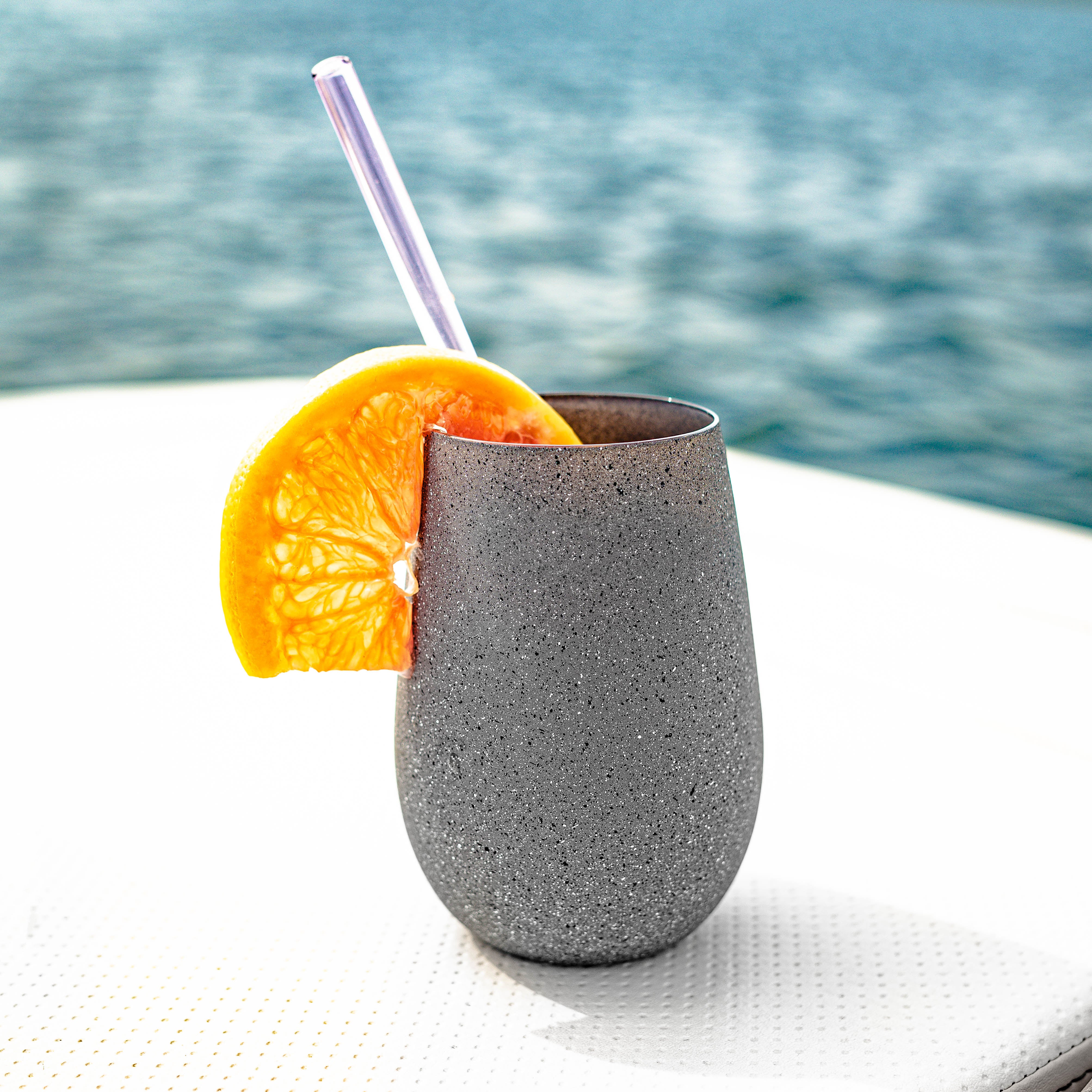Graues Stölzle Lausitz Glas für Cocktails mit Orangenscheibe und Strohhalm, ideale deutsche Gläser für Cocktails